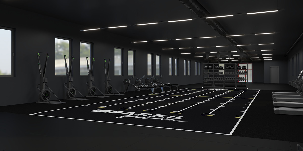 Innenansicht eines modernen Fitnessstudios mit Rudergeräten und Gewichten auf Regalen.